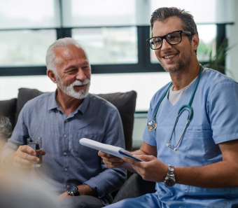 Nurse standing next to a patient